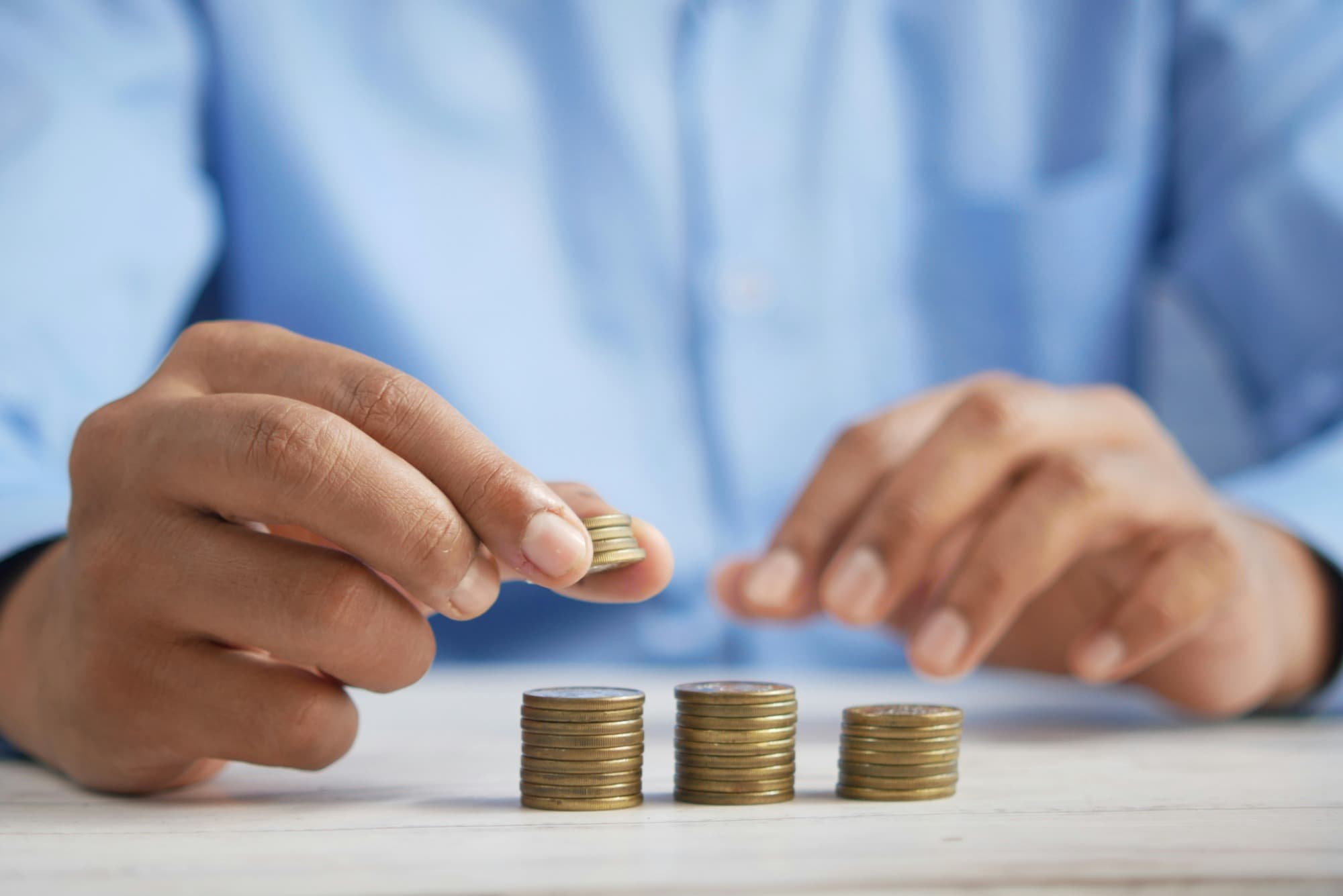 A close up shot of hands stacking coins